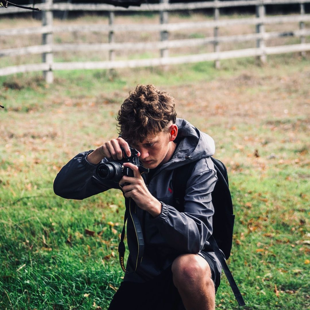 Harry photographing outdoors with a camera